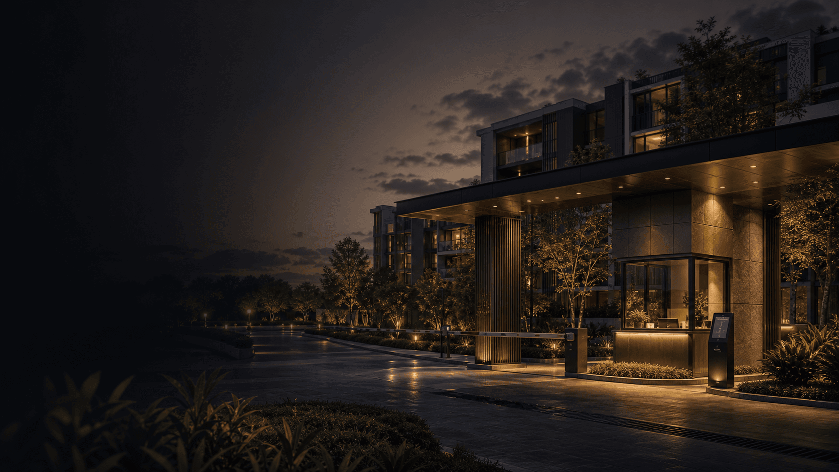 A secure residential community entrance at dusk with warm lights and a calm operations desk